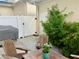 Outdoor patio with white privacy fence and wooden chairs at 319 Celebration Blvd, Celebration, FL 34747