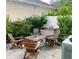 Cozy patio space with a dining table set, lush plants, and relaxed outdoor furniture, perfect for relaxation at 319 Celebration Blvd, Celebration, FL 34747