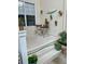 Outdoor patio area featuring plants in decorative wall mounted planters, steps leading to the door and cozy seating at 319 Celebration Blvd, Celebration, FL 34747