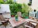 Serene patio featuring comfortable seating, verdant plants, and an air conditioning unit, perfect for quiet relaxation at 319 Celebration Blvd, Celebration, FL 34747