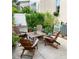 Inviting patio with lush greenery, Adirondack chairs, and a charming outdoor table set for relaxing and entertaining at 319 Celebration Blvd, Celebration, FL 34747