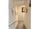 Carpeted stairs lead to the next level, featuring light-colored walls adorned with art and a white handrail at 319 Celebration Blvd, Celebration, FL 34747