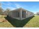 An outdoor covered patio and a glimpse of the rear of the home at 4235 Sawtooth Ct, Tavares, FL 32778