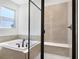 Bathroom with tub and shower stall with a built-in bench at 4235 Sawtooth Ct, Tavares, FL 32778