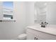 Modern bathroom featuring white cabinets, a sleek vanity, and a shower with glass doors at 4235 Sawtooth Ct, Tavares, FL 32778