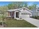 Charming single-Gathering home featuring a two-car garage and appealing curb appeal with a landscaped front yard at 4235 Sawtooth Ct, Tavares, FL 32778