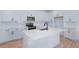 Modern kitchen featuring white cabinetry, stainless steel appliances, and a large kitchen island at 4235 Sawtooth Ct, Tavares, FL 32778