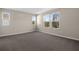 Spacious bedroom with large windows, neutral walls, and plush carpet at 535 Summit River Dr, Apopka, FL 32712