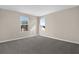 Bright bedroom with neutral walls, plush carpet, and plenty of natural light from two windows at 535 Summit River Dr, Apopka, FL 32712