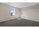 Empty bedroom featuring plush carpeting, neutral walls, and a window offering natural light at 535 Summit River Dr, Apopka, FL 32712