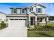 Charming two-story home featuring a two-car garage, stone accents, blue shutters and landscaped front yard at 535 Summit River Dr, Apopka, FL 32712