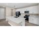 Modern kitchen with stainless steel appliances, white cabinetry, island and a pantry at 535 Summit River Dr, Apopka, FL 32712