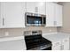 The kitchen features stainless steel appliances, white cabinets, and quartz countertops at 535 Summit River Dr, Apopka, FL 32712