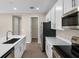 Modern kitchen with stainless steel appliances, white cabinetry, island and a pantry at 535 Summit River Dr, Apopka, FL 32712