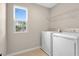 Convenient laundry room with modern appliances, shelving, and a window for natural light at 535 Summit River Dr, Apopka, FL 32712