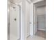 Modern bathroom featuring a glass-enclosed shower and neutral tiling with an entry to the walk-in closet at 2111 Riely Ave, Eagle Lake, FL 33839