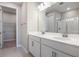 Bathroom with a double sink vanity with white cabinetry, neutral wall paint, large mirror, and a shower stall at 2111 Riely Ave, Eagle Lake, FL 33839