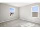 Well-lit bedroom with soft carpet, two windows, and neutral wall paint at 2111 Riely Ave, Eagle Lake, FL 33839