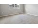 Empty bedroom with carpet, neutral wall paint, white trim, and a bright window at 2111 Riely Ave, Eagle Lake, FL 33839