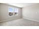 Bright bedroom with two windows providing ample natural light and plush carpeting at 2111 Riely Ave, Eagle Lake, FL 33839