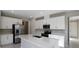 Modern kitchen with stainless steel appliances, a center island, white cabinets, and stylish fixtures at 2111 Riely Ave, Eagle Lake, FL 33839