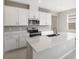 Modern kitchen with stainless steel appliances, a center island, white cabinets, and stylish fixtures at 2111 Riely Ave, Eagle Lake, FL 33839
