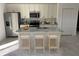 Kitchen island with granite countertops and breakfast bar seating at 6142 Sw 154Th Place Rd, Ocala, FL 34473