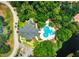 Aerial view of community clubhouse and pool surrounded by lush trees at 62 Coquina Ridge Way, Ormond Beach, FL 32174