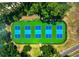 Aerial view of community pickleball courts surrounded by lush trees at 62 Coquina Ridge Way, Ormond Beach, FL 32174
