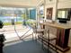 Screened in lanai with bar and seating area overlooks a beautiful pond at 62 Coquina Ridge Way, Ormond Beach, FL 32174