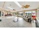 Bright living room features tile flooring, ceiling fans, and large windows at 62 Coquina Ridge Way, Ormond Beach, FL 32174