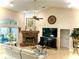 Cozy living room with a marble fireplace, recessed lighting, and access to the lanai at 62 Coquina Ridge Way, Ormond Beach, FL 32174
