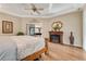 Inviting main bedroom with an electric fireplace and access to the screened lanai at 62 Coquina Ridge Way, Ormond Beach, FL 32174
