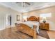 Spacious main bedroom features tray ceiling, wood floors, and an ensuite bathroom at 62 Coquina Ridge Way, Ormond Beach, FL 32174