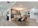 Modern dining room with stylish light fixture, designer accent wall, and beautiful flooring at 715 Eastover Cir, Deland, FL 32724