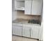 Close-up of kitchen sink and white cabinets at 7900 S Orange Blossom Trl # 1120, Orlando, FL 32809