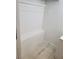 Simple laundry room with shelves and tile floor at 7900 S Orange Blossom Trl # 1120, Orlando, FL 32809