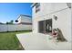 Fenced backyard with patio and seating area at 1746 Pompano Dr, Poinciana, FL 34759