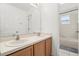 Bright bathroom featuring double sinks, white cabinets, and a shower and bathtub combination at 1746 Pompano Dr, Poinciana, FL 34759