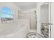 Bathroom boasts a soaking tub, shower, and updated flooring at 1746 Pompano Dr, Poinciana, FL 34759