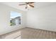 Sunny bedroom featuring a ceiling fan and a large window at 1746 Pompano Dr, Poinciana, FL 34759