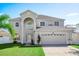 Charming two-story home with a well-manicured lawn at 1746 Pompano Dr, Poinciana, FL 34759