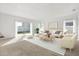 Inviting living room with a sliding glass door, comfortable seating, and a stylish striped rug at 1746 Pompano Dr, Poinciana, FL 34759