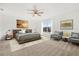 Spacious bedroom with a ceiling fan, large window with a view, and comfortable seating area at 1746 Pompano Dr, Poinciana, FL 34759