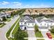 An elevated aerial view captures neighborhood homes, tree lined street and expansive green lawns at 9099 Hazard St, Davenport, FL 33896