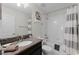 Well-lit bathroom featuring a granite vanity, tub-shower combo, and modern fixtures at 9099 Hazard St, Davenport, FL 33896
