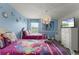 Adorable 'Frozen' themed bedroom with two beds, ceiling fan, and entertainment center at 9099 Hazard St, Davenport, FL 33896