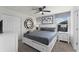 Relaxing gray-themed bedroom with a queen bed, white dressers and closet, and a window view at 9099 Hazard St, Davenport, FL 33896