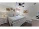 Comfortable bedroom with white furniture and a ceiling fan for a relaxing and restful atmosphere at 9099 Hazard St, Davenport, FL 33896
