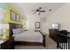 Spacious bedroom with warm lighting, dark wood furniture, and a view of the television at 9099 Hazard St, Davenport, FL 33896